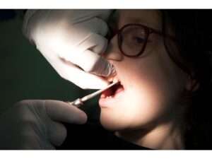 Doctor performing the comfortable and stress-free Tooth Extractions